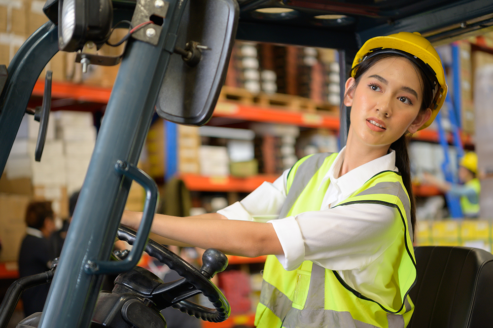 647888ca92d03e3fca3f2460 female worker driving a forklift moving goods in t 2022 09 27 23 18 16 utc