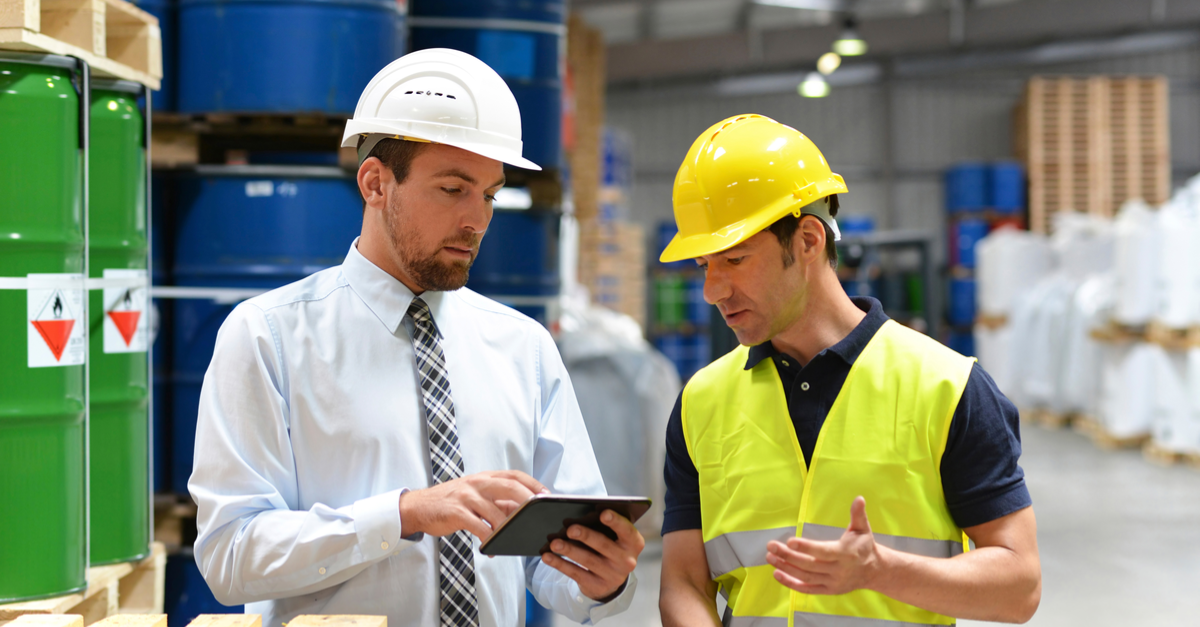 5 Keys to Ensure Employee Safety When Storing Hazardous Materials 2 two men in hardhats looking at tablet