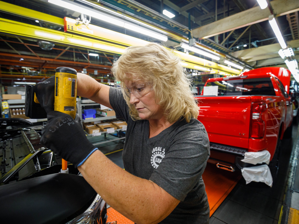 blonde lady working on car