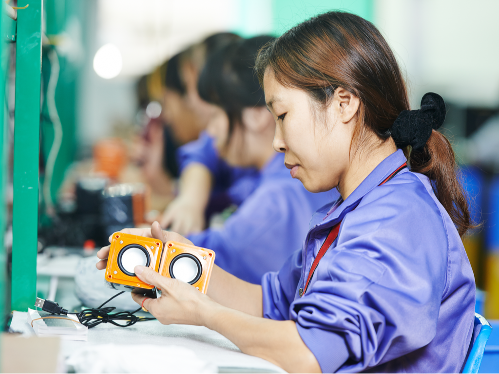 factory worker with small speakers