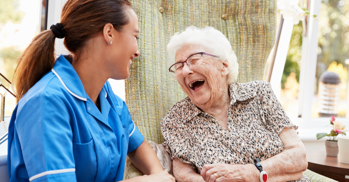a nurse and an old lady laughing together