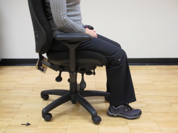 woman sitting in chair with feet flat on the floor
